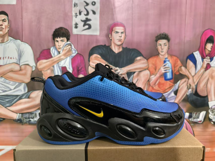 Side view of blue and black Nike sneakers with yellow accent branding and textured blue panels.