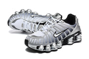 Pair of silver Nike Shox TL sneakers shown from above and at an angle.