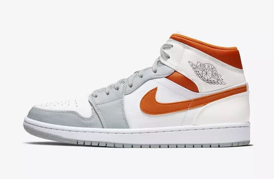 Side view of white, orange, and gray Jordan high-top sneakers with an orange Swoosh, gray toe overlay, orange padded collar, Air Jordan wing branding, and a rubber outsole.
