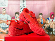 Angled side view of red Nike basketball shoes with black Swoosh details.