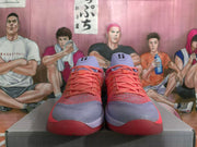 Front view of coral and lavender Nike basketball shoes.