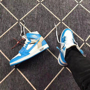 Pair of blue and white high-top sneakers displayed on a patterned floor, including a loose shoe and alternate laces.