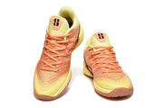 Pair of yellow and orange Nike Kobe basketball shoes viewed from the front.