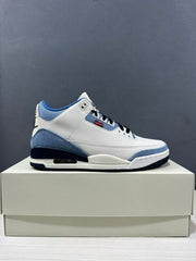 Clean side profile of the white and blue Jordan sneaker on a shoebox.