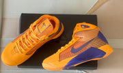 Top and side views of the shoes on a black surface