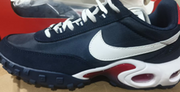 Close side view of a navy Nike Air Max Waffle SP sneaker with a white Swoosh and red midsole accent.