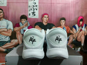 Rear view of white Nike A'ja sneakers showing A'ja heel lettering and black outsole accents.