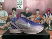 Side view showing the textured purple upper, light-colored Swoosh, checkerboard heel panel and Nike Zoom sole branding.