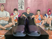 Front view of dark purple and black Nike basketball sneakers showing black laces, perforated toes and translucent outsoles.