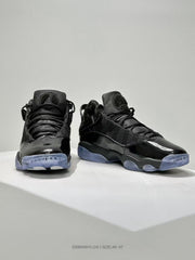 Front three-quarter view of black high-top sneakers with glossy toe panels, layered uppers, and translucent blue outsoles.