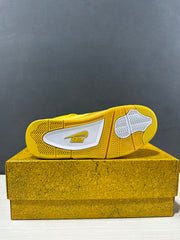Underside view of the yellow sneaker showing a patterned rubber outsole with white sections.