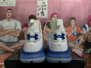 Rear view of white and blue high-top basketball shoes with Under Armour logos.