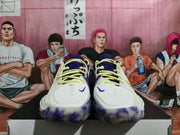Front view of white Nike basketball sneakers with purple uppers, yellow laces, and purple outsole accents.