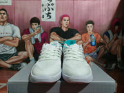 Pair of white Nike basketball sneakers shown from the front with silver detailing and a textured outsole.