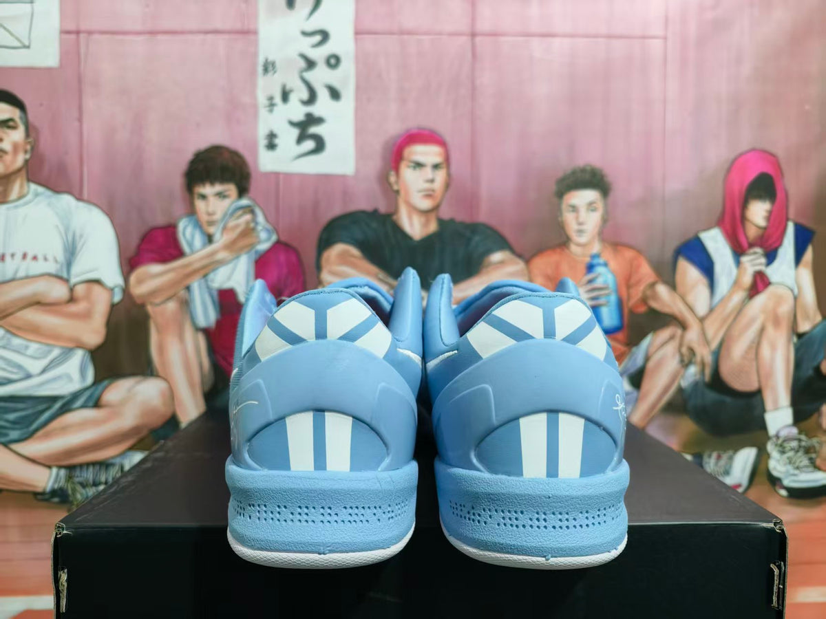 Rear view of blue Nike shoes showing white-and-blue heel details and a perforated heel area.