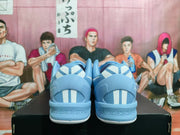Rear view of blue Nike shoes showing white-and-blue heel details and a perforated heel area.