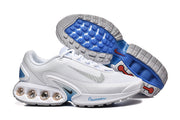 Nike Air Max DN sneakers shown from the side and underside, with blue outsole accents and visible heel cushioning.