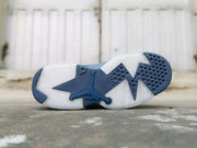 Outsole view showing the white and dark blue traction pattern with a Jordan silhouette.