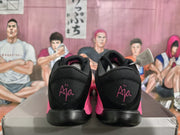 Rear view showing the black heel panels and pink A'ja-style graphic detail.