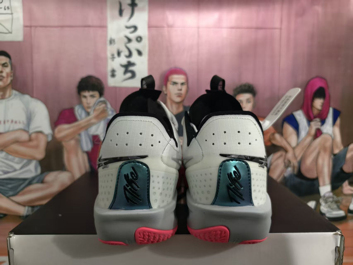 Rear view of white and pink Nike basketball sneakers positioned on a shoebox.