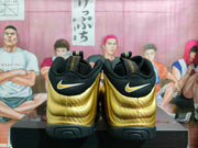 Rear view of the pair showing gold heel panels, black collars, heel Swoosh branding, and pull tabs.