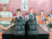 Rear view of the sneakers showing EYBL heel graphics and speckled black midsoles.