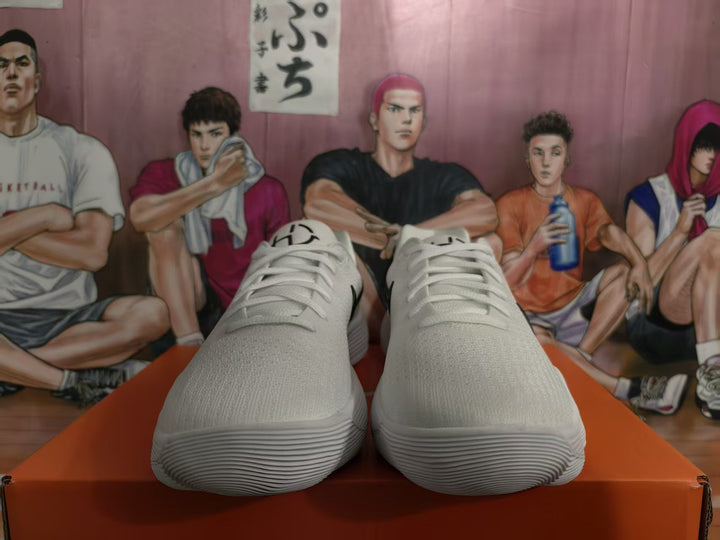 Pair of white Nike sneakers shown from the front with white laces and textured soles.