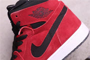 Close-up of the red upper, black Swoosh, stitching, and embossed Jordan ankle branding.