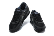Pair of black Nike Air Max 90 sneakers shown from above and the front.