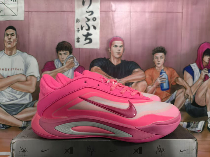 Side view of pink Nike basketball shoes with layered side panels, a visible Swoosh, and molded midsole details on a shoe box.
