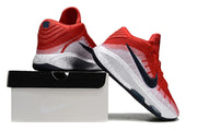 Red and white Nike GT Hustle 3 shoes posed on and beside a shoe box.