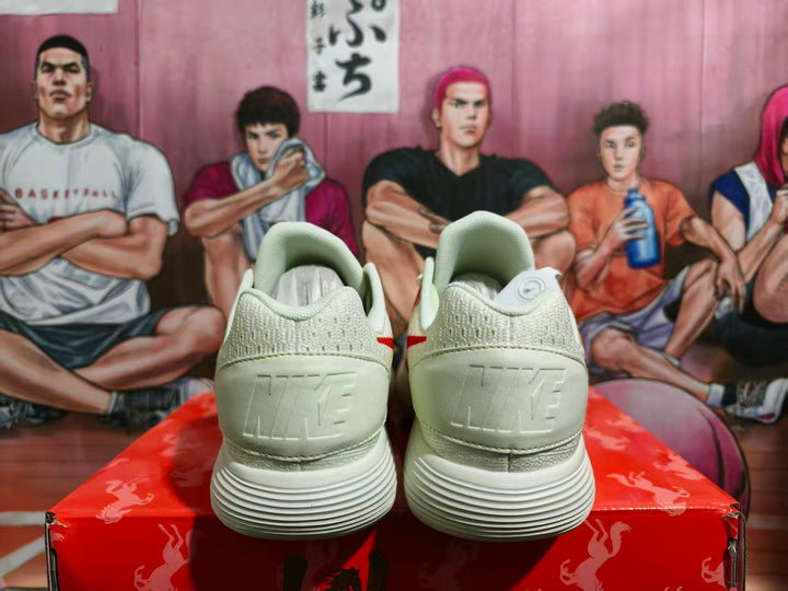 Rear view of cream Nike sneakers showing embossed heel branding, padded collars, and ribbed outsoles.