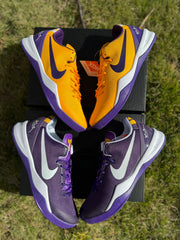 Purple and gold Kobe 8 shoes arranged together, showing both color panels.