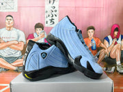 Angled view of light blue and black Jordan 14 sneakers with perforated side panels.