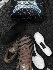 Close view of the patterned brown upper, laces, tongue branding and white cushioning components.