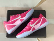 Angled top-down view highlighting the silver Swooshes, pink overlays, and translucent outsoles.