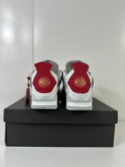 Rear view showing red heel panels with gold decorative emblems and white-gray midsoles.