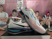 Pair of white and blue Nike basketball sneakers shown from the side, with black Swoosh branding and layered blue and black sole details.