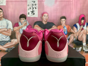 Rear view showing the deep pink heel panels, basketball player emblems, and pale heel structures.