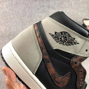Close-up of the gray heel panel, Air Jordan wing branding, and bronze-toned Swoosh.