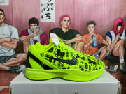 Side view of a bright green basketball sneaker with black graphic print, black Swoosh, and visible Nike Zoom wording.