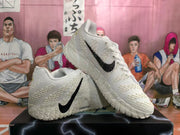 White Nike basketball sneakers shown from the side and at an angle
