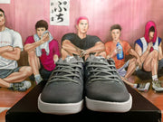 Front view of gray lace-up Kobe basketball shoes with white soles