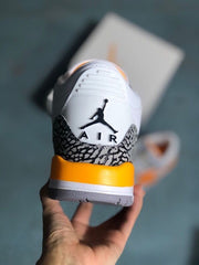 Rear view of the sneaker with elephant-print heel panel and orange midsole accent.