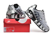Nike Shox TL sneakers displayed with a red Nike shoebox; the box label shows a sample size.