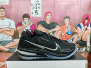 Side profile of a black Nike basketball sneaker showing the textured upper, large side branding, speckled midsole, and translucent outsole.