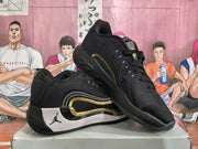 Angled view showing the black uppers, white and gold side detailing, and layered soles.
