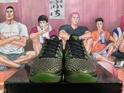 Front view of black Nike basketball sneakers with green textured panels and green outsoles
