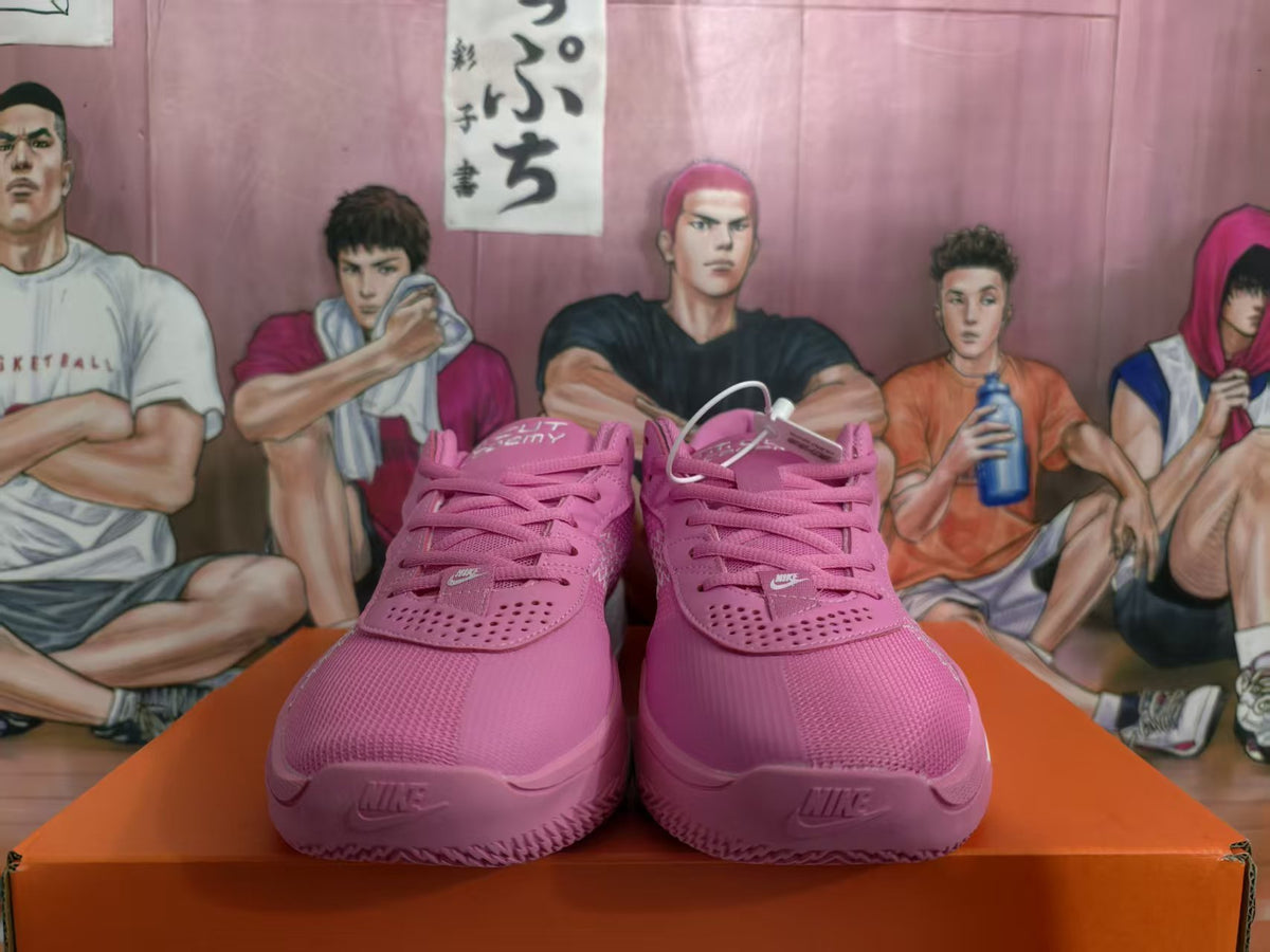 Front view of pink Nike basketball sneakers with perforated toe panels, laces, and white Nike logos.