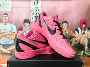 Pair of pink Kobe basketball shoes with black accents, shown from the side.